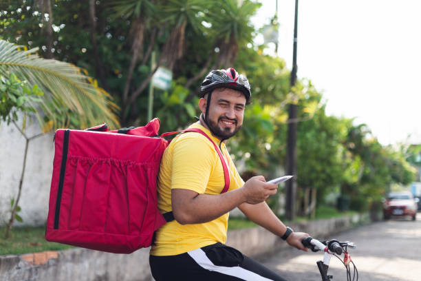 istock Portrait of a delivery man on bicycle with backpack 1433936045