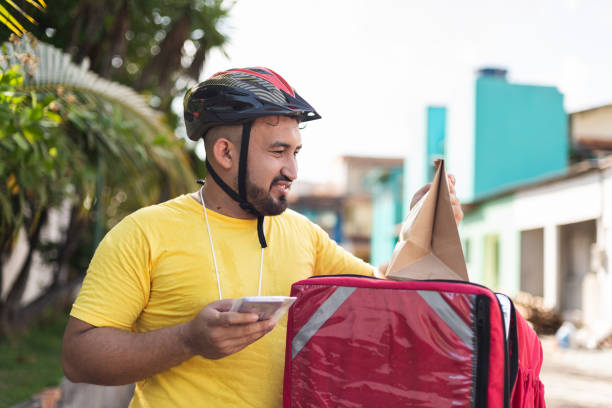 istock Portrait of a delivery man on bicycle with backpack 1433936633
