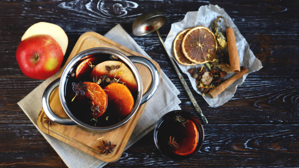Saucepan with hot mulled wine. Spices and citrus. Christmas drinks. Cooking mulled wine. stock photo