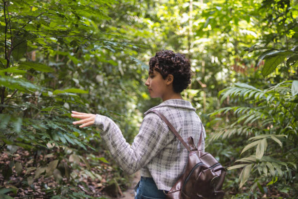 istock Young woman walking alone in the forest 1433943734