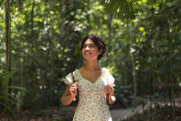 istock Young woman walking alone in the forest 1433945049