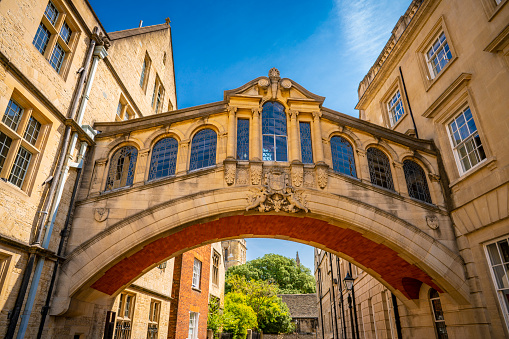 Oxford, England - June 19, 2013: Students relaxing on the grass outside Balliol College of Oxford University