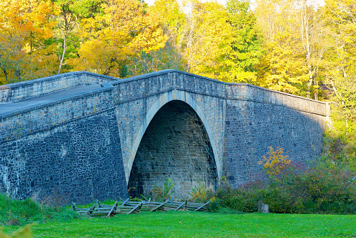 Grantsville, Maryland, USA - October 10, 2022: The historic Casselman River Bridge, built between 1813-1814, is located in Casselman River Bridge State Park, a Maryland park located in “Mountain Maryland” in Garrett County.