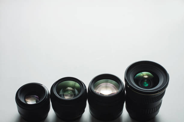 close-up view of a group of camera lenses on a white surface