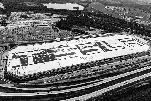 Aerial view of a large distribution centre warehouse on the outskirts of a large city being built and under construction