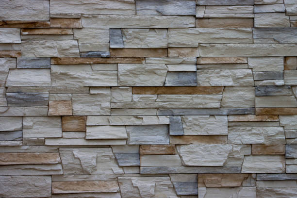 istock Gray decorative uneven cracked stone wall surface with cement. 1433973934