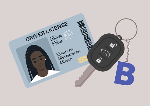 A driver license plastic card with a photo, a car starter key with a keychain