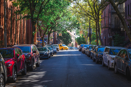 A Taxi turns onto a historic street in Brooklyn, NY. USA