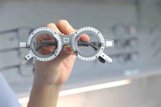 istock Female doctor's hand holding an eye test device inside an ophthalmologist 1433999950