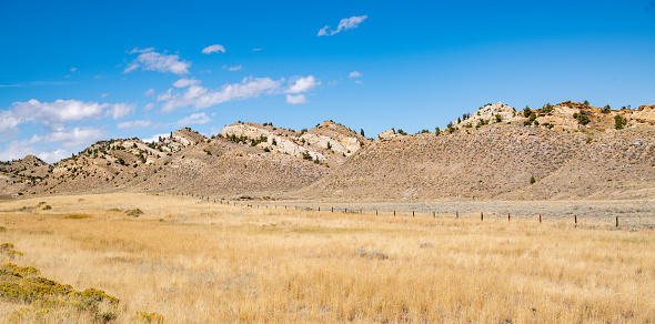 The plains and mountains of Wyoming along highway to Cody, Wyoming in western USA.