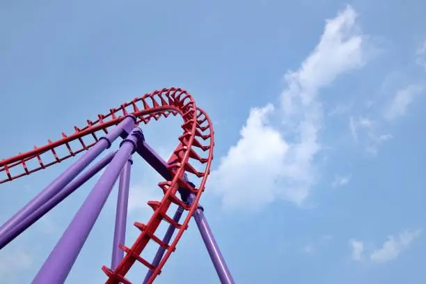 Photo of Roller coaster twisting rail track at fun park.