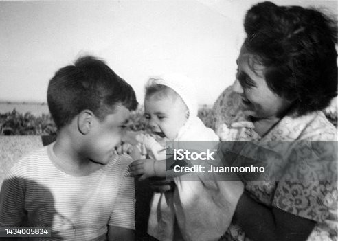 istock Image taken in the fifties, smiling woman posing with her son and daughter 1434005834