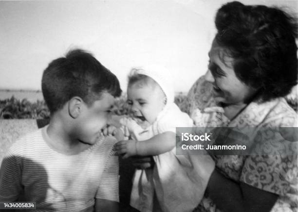 Image Taken In The Fifties Smiling Woman Posing With Her Son And Daughter Stock Photo - Download Image Now