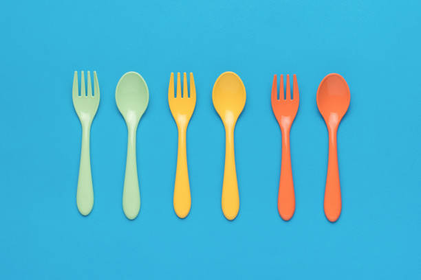 istock Plastic spoons and forks on a blue background. Minimal concept of plastic tableware. 1434010831