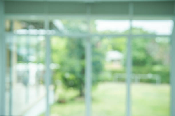 istock Interior view looking out toward to Green natural garden Blur background, Window view with Blur green bokeh light outdoor natural garden. 1434013985
