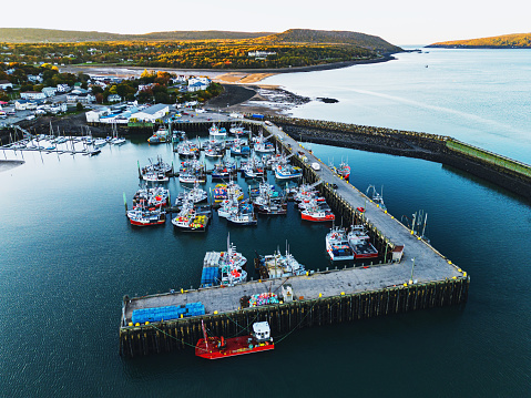 Aerial drone view of a small town fishing wharf just before sunset.