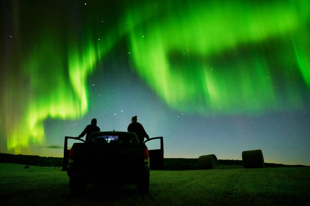 istock Couple watching northern lights from their pick-up truck 1434023621