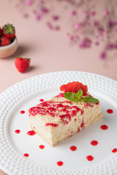 istock white plate and cake, Slice of plain cheesecake on white plate. with Cream Puffs Eclairs 1434025127