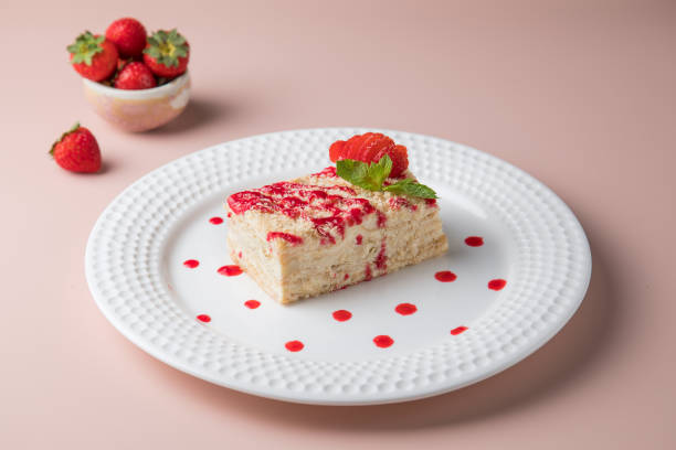 istock white plate and cake, Slice of plain cheesecake on white plate. with Cream Puffs Eclairs 1434025780