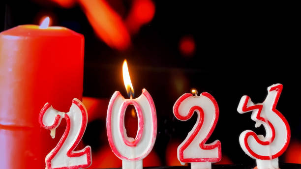 istock 2023 made by candles burning on black background. Mourning, condolence and sorrow concept. Copy space 1434027498