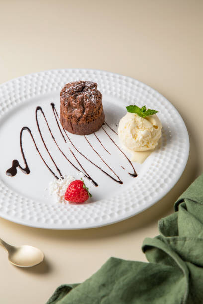 istock white plate and cake, Tiny cupcake with strawberry on top of a gray concrete background. 1434028288