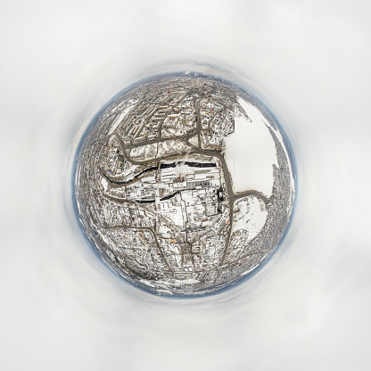 Winter embankment of the city Nizhny Tagil and metallurgical plant from above. Problem of environmental pollution and air in large cities. Aerial view. Little planet sphere mode. Nizhny Tagil, Russia