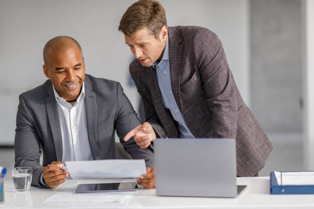 istock Male entrepreneurs analyzing business reports in the office. 1434045755