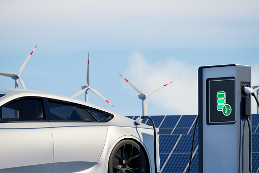 Modern sports electric car charging on background of solar panels. EV station with port plugged in environmentally friendly vehicle. Realistic 3d Rendering renewable energy concept solar wind power.