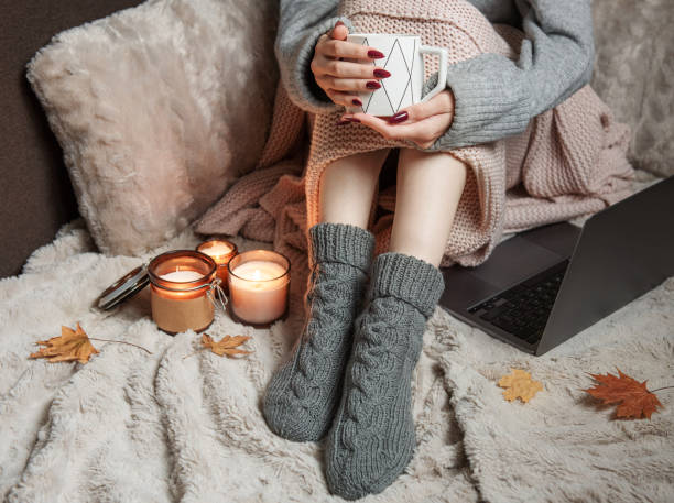 istock Cozy home, woman covered with warm blanket, drinks coffee. 1434051667