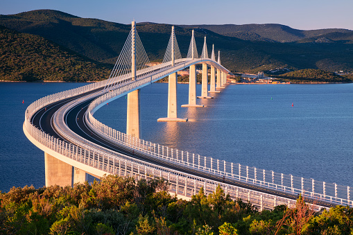 Image of beautiful modern multi-span cable-stayed Peljesac Bridge over the sea in Dubrovnik-Neretva County, Croatia at sunrise.