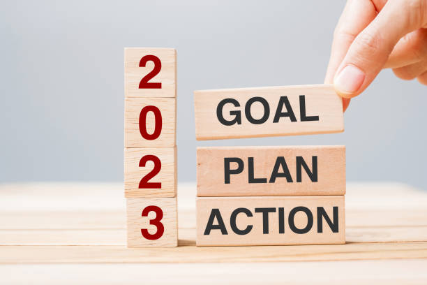 istock hand holding wooden block with text 2023 GOAL, PLAN and ACTION on table background. Resolution, strategy, solution, goal, business and New Year holiday concepts 1434055286
