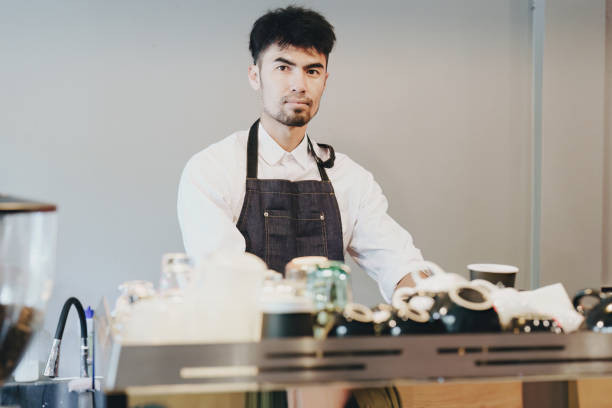 istock Asian male barista making coffee for customers 1434057506