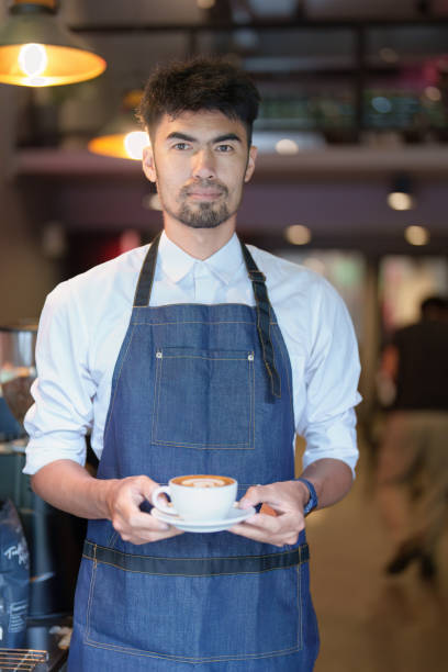istock Asian male barista making coffee for customers 1434057689