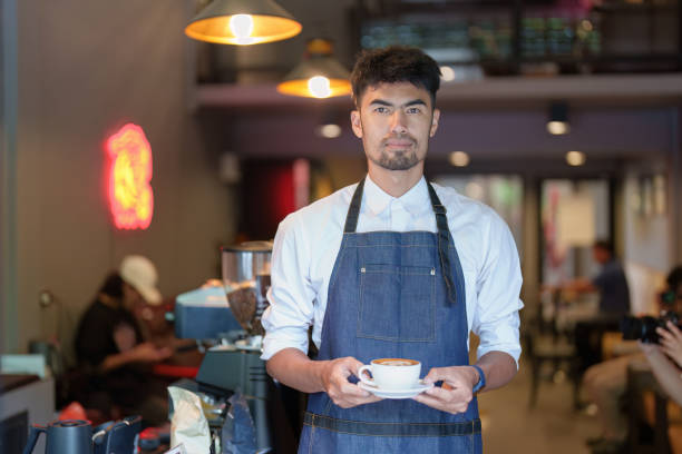 istock Asian male barista making coffee for customers 1434057706