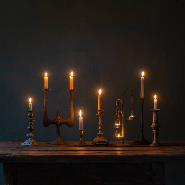 istock burning candles in vintage candlesticks on dark background 1434057771