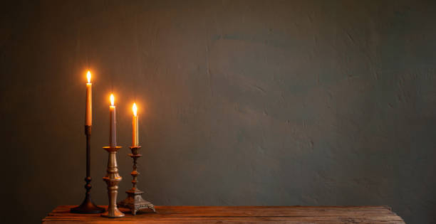 istock burning candles in vintage candlesticks on dark background 1434057772