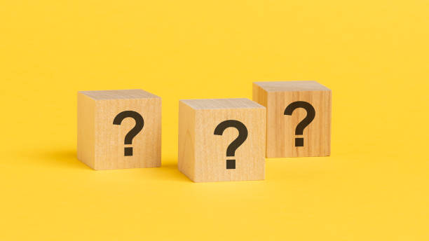 istock front view on wood cubes with question marks. many question arising concept, yellow background 1434058843