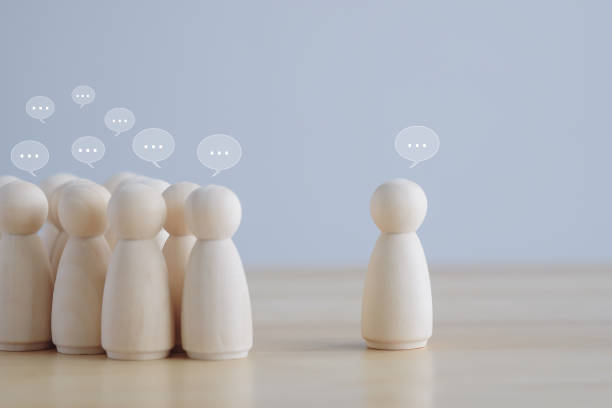 istock Leader. Leadership. Team discussion, Community or social feedback. Communication or announcement dialog. Business meeting. Teamwork and communication concept. Many wooden figure with speech bubble. 1434059812