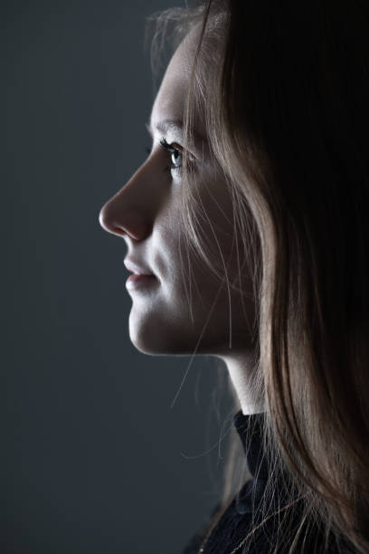 istock Low light side view of woman studio portrait 1434062102