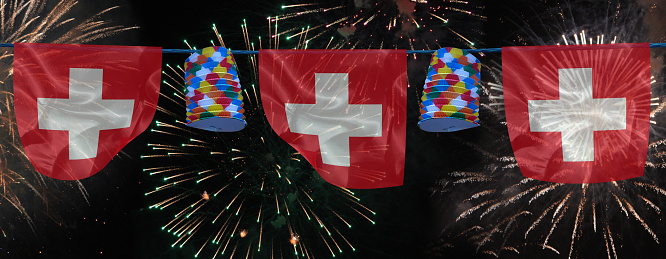Panoramic of a firework   Garland of lanterns and Swiss flags   Festivities  Public event
