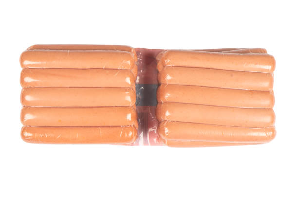 istock Sausages in vacuum plastic packaging isolated on white background. Vacuum transparent packaging with fresh sausages. A pack of sausages in a vacuum foil isolated. 1434063476