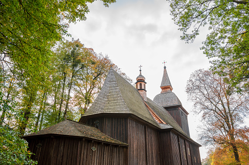 St. Nicholas in Polanka Wielka. Timber architecture with a log structure. The temple is covered with shingles and the facade is made of wooden boards in a vertical arrangement. Polanka Wielka, Poland