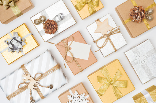 Decorative wrapped gift boxes arranged in rows on white background