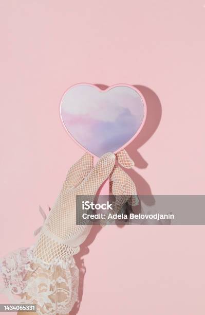 Valentines Day Creative Layout With Woman Hand Holding Heart Shaped Mirror With Pink Clouds Reflection On Pastel Baby Background 80s 90s Retro Romantic Aesthetic Love Concept Minimal Fashion Idea Stock Photo - Download Image Now