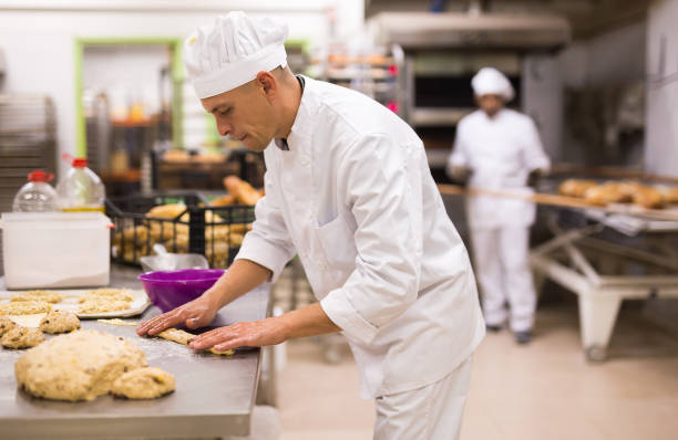 istock portrait male baker making cookies in bakehouse 1434066144