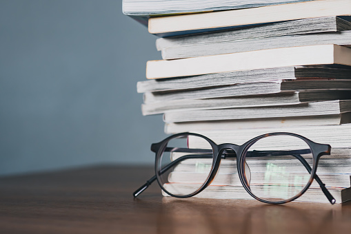 Eyeglasses and a stack of books