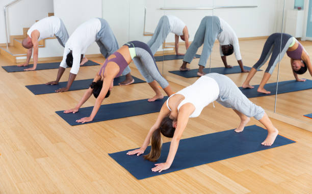 istock Multiethnic group of young people practicing yoga 1434066671