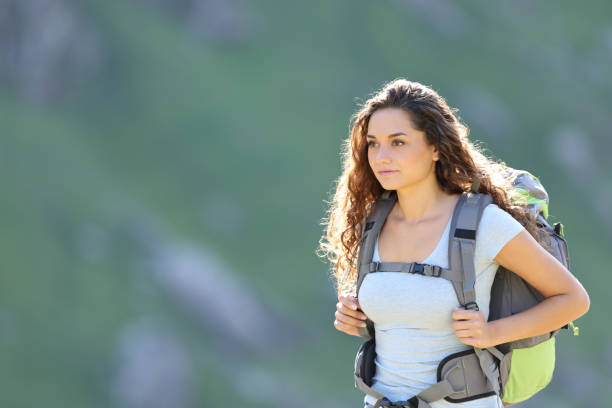 istock Hiker woman walking in the mountain wearing backpack 1434067208
