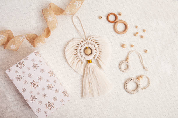 istock Christmas macrame decor. Christmas angel and decorative elements on white backgtound. Natural materials - cotton thread, wood beads. Eco decorations, ornaments, hand made decor. Copy space 1434071171