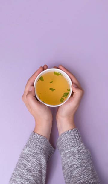 istock Hands holding a takeaway cup with Chicken broth soup 1434072108